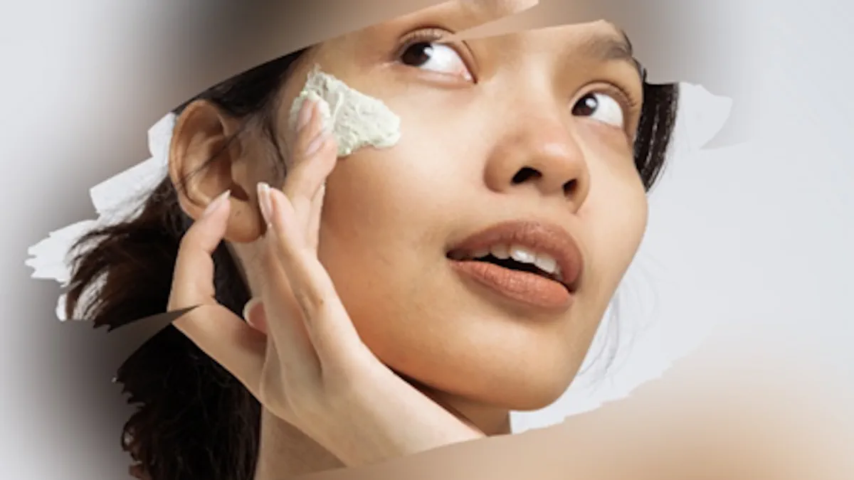 Woman applying beauty cream